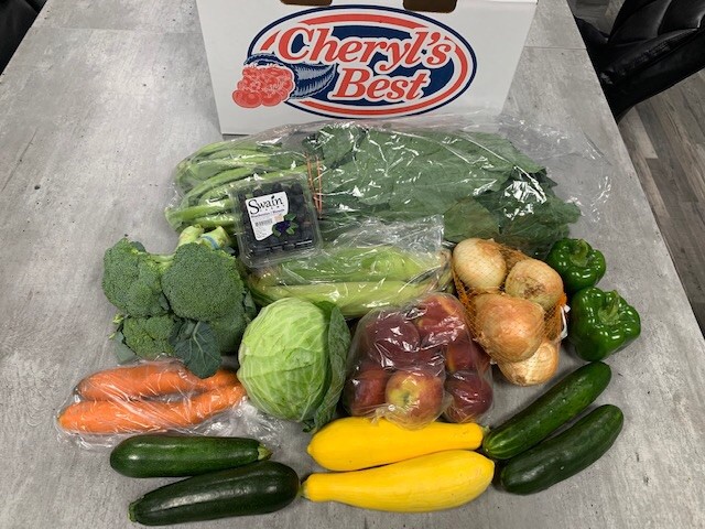 A basket of food containing 20 pounds of different fruit and vegetables.