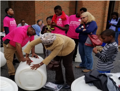 Participants make rain barrels.