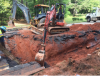 Crews continue to repair near water main on Henderson Mill Road