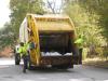 Sanitation workers collect refuse.