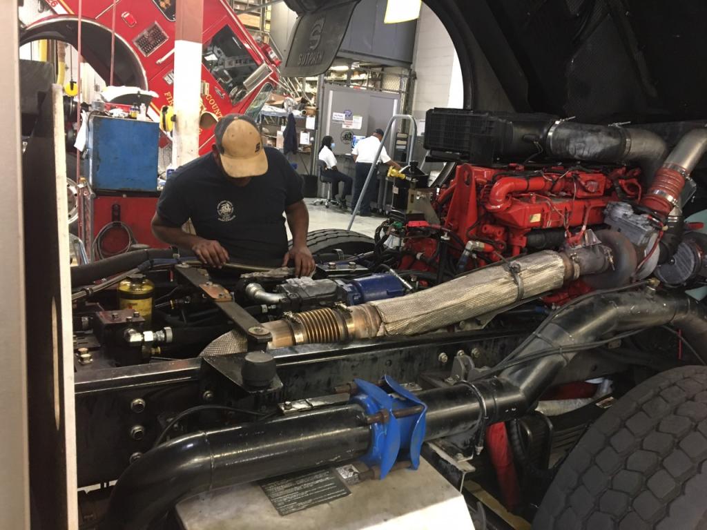 Mechanic working on heavy truck engine