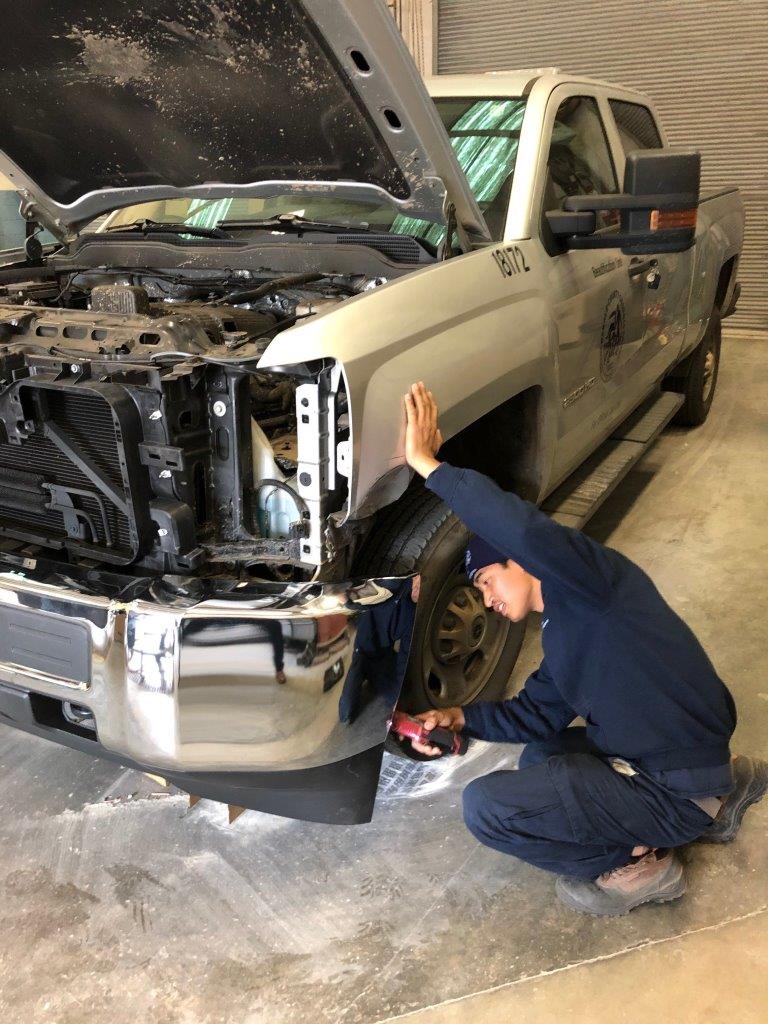 An apprentice working on a vehicle