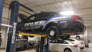 police cruiser on rack in shop