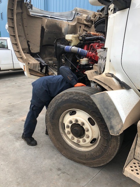 technician inspecting heavy truck